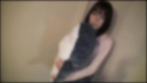 Blurry JAV thumbnail of sexy Japanese woman in white top and dark scarf leaning seductively