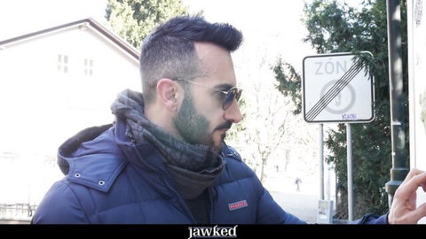 Johnny Viper in blue jacket and sunglasses outdoors, teasing gay raw anal scene
