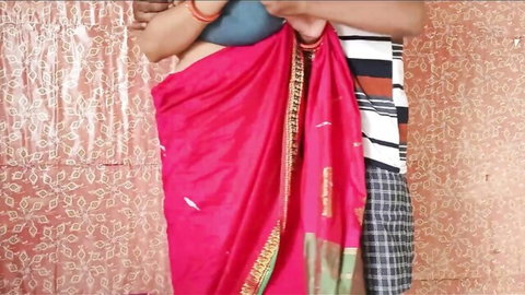 Indian couple foreplay with man groping woman's bare midriff under red saree