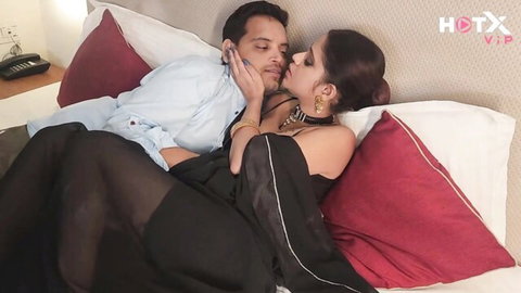 Indian Bhabhi in sheer black saree passionately kissed by Devar, intimate couple embrace