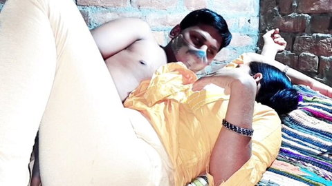 Shirtless South Asian man cuddles masked Indian woman in naughty intimate embrace on bed
