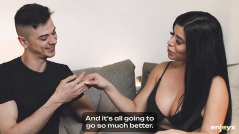 Sara Retali in sexy lingerie with partner on couch, intimate smile