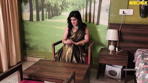 Indian bhabhi Kixx in golden saree, seductive seated pose