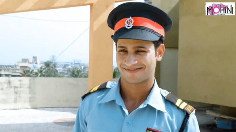 Smiling Indian security guard in blue uniform on rooftop, teasing steamy MILF maid hookup