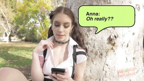 Anna De Ville in teasing schoolgirl outfit outdoors, surprised expression