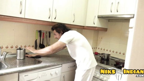 Indian man in tight white pants bends over kitchen sink teasing his ass