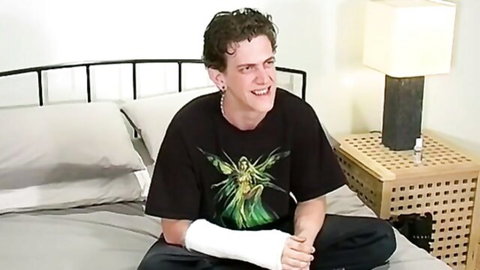 British hunk Brad smiling in kinky solo interview, arm cast and fairy tee