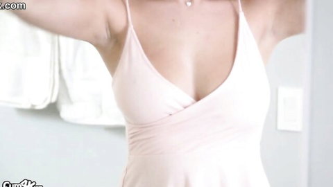 Blake Blossom posing seductively in pink dress with deep cleavage