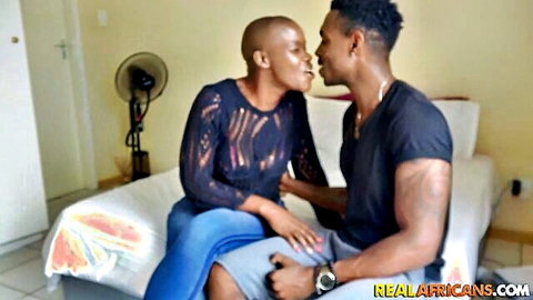 Bald busty black Congolese woman kissing ebony man intimately