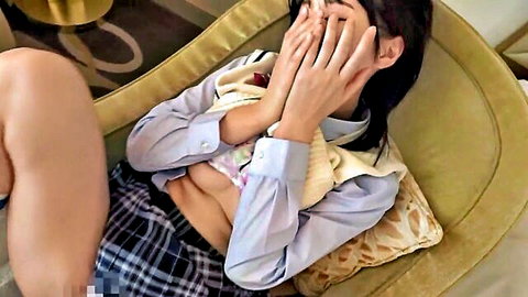 Shy Japanese schoolgirl in uniform covering face, teasing midriff exposure