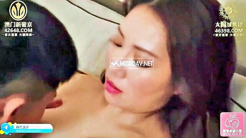 Asian babe with red lips passionately kissed on neck by muscular guy in hotel room