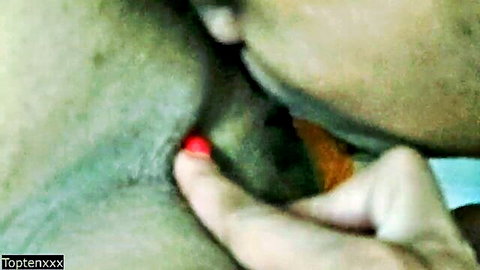 Blurry close-up hand pressing red pill on hairy skin neck greenish tint