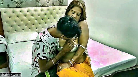 Indian man gropes mature woman's bare tit in steamy bedroom foreplay