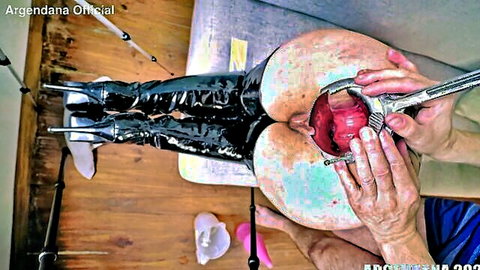 Huge ass MILF in latex boots has red anal plug yanked from gaping anus with pliers