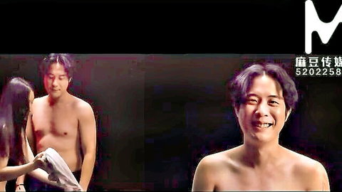 Chinese babe kneels grabbing shirtless hunk's towel-covered cock in steamy Asian episode
