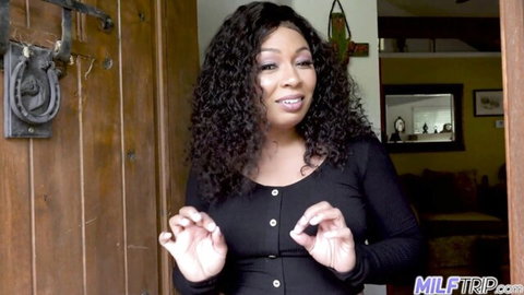 Anita Peida, curvy Black MILF in tight black top, smiling teasingly