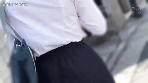 Japanese office lady in white blouse and black skirt, side view with green bag, teasing JAV thumbnail
