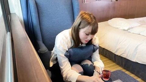Asian Angel 11915 in open white blouse exposing chest, ripped jeans, sipping tea solo