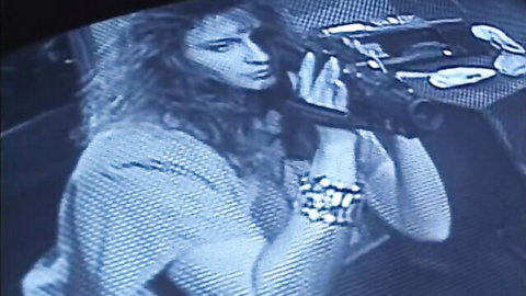 Vintage lesbian classic porn thumbnail: curly-haired woman holding camcorder in intimate setup