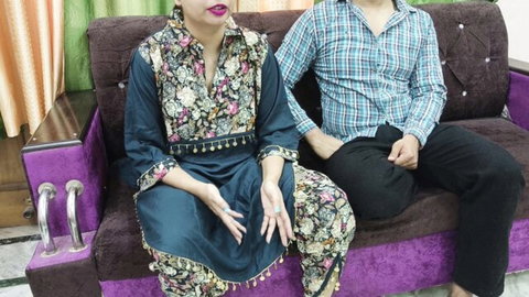 Desi Indian stepmom in traditional salwar kameez with stepson on couch, teasing pose