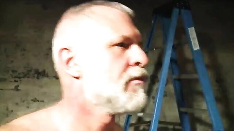 Muscular silver DILF with gray beard shirtless near blue ladder