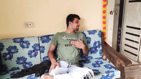 Handsome Desi man in green t-shirt and ripped jeans lounging casually