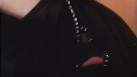 Steamy Thai maid in sheer black lingerie displaying deep cleavage and beaded necklace