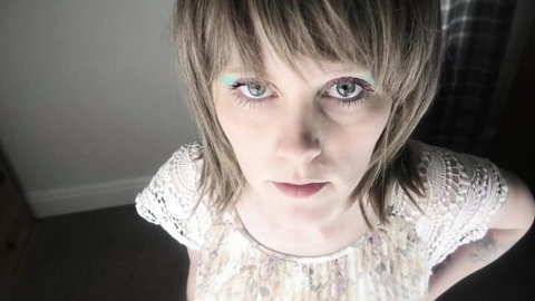 Sydney Harwin in seductive lace top with intense green-eyed stare