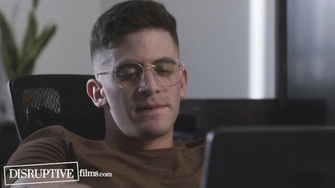 Zak Bishop in fitted shirt and glasses, teasing office coworker hookup