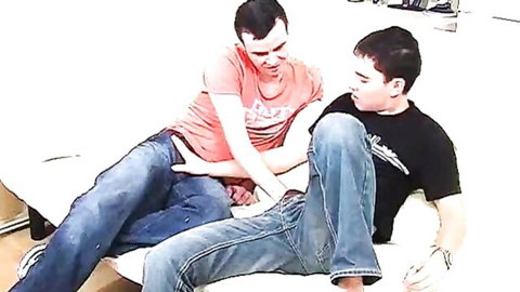 Two athletic men grappling intimately in amateur homemade video
