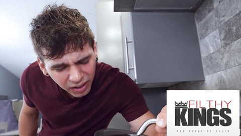 Young guy with messy hair grimaces mouth open in kitchen Filthy Kings scene