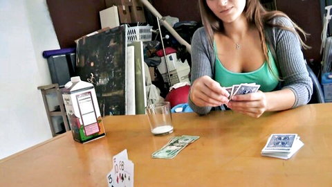 Brunette in cardigan shows cleavage while playing naughty card game