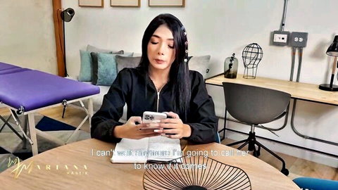 Mariana Martix Latina beauty sitting casually in black hoodie, tense expression