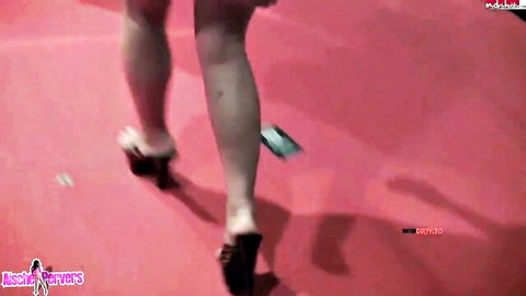 Aische Pervers struts in high heels and short dress on red stage