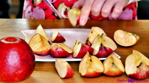 Jenny Wild slicing red apples into wedges on a plate