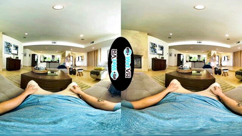 Kenzie Reeves in VR footjob scene, legs spread on couch