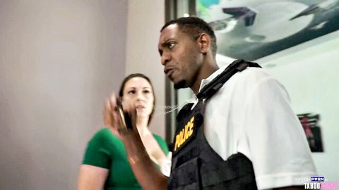 Melanie Hicks chats with black cop in uniform in Gotham parody scene