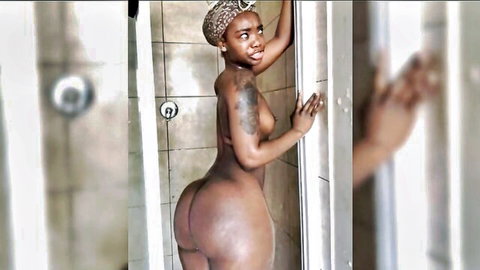 Hot ebony babe teasing her curves in steamy shower nude