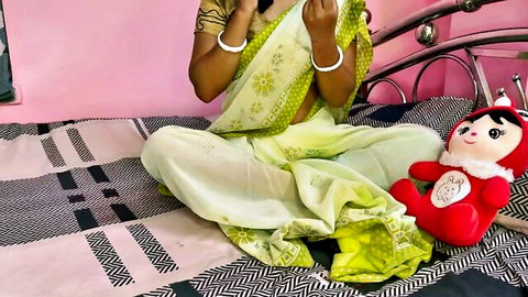 Sexy Indian Bhabhi in green saree posing playfully with teddy bear