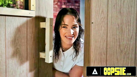 Siri Dahl wet and smiling, peeking from door in see-through shirt