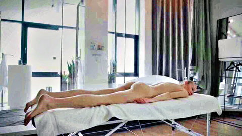 Nude slim woman lying face down on massage table for deep erotic session
