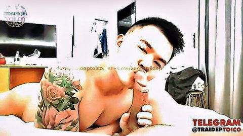 Tattooed Asian hunk sucking cock on bed, explicit oral action