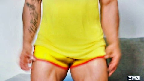 Muscular Mateo Zagal in tight yellow shorts and tank top, bulging crotch