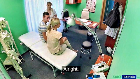 Blonde patient sits clothed on exam bed with male doctor as nurse watches in fake hospital roleplay