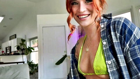Redhead babe with huge tits in shiny green bikini top under open plaid shirt flashing cleavage