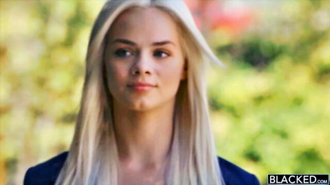 Young blonde beauty with long hair smiling seductively outdoors for Blacked interracial porn