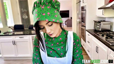Natalie Brooks in sexy green floral apron teasing in kitchen