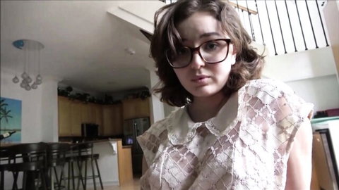 Young brunette teen in glasses and sheer lace blouse teasing perky tits in kitchen