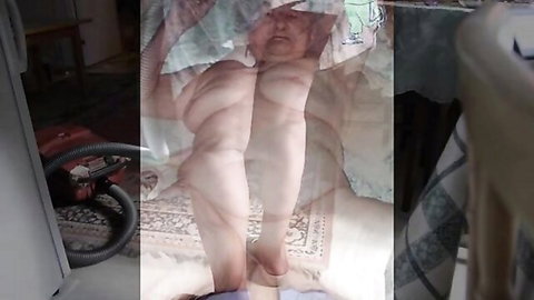 Blurry naked mature woman lies on floor with legs spread wearing white diaper exposing saggy tits