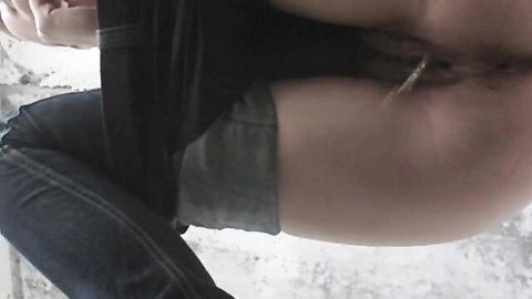 Hand pulling labia piercing on skinny girl's tight shaved pussy in bathroom